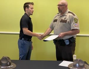 Christopher Huck is shown being sworn in by Chief Patrick Brockmeier (Hocking College Alumni & Instructor) at the Muskingum Watershed Conservancy District.